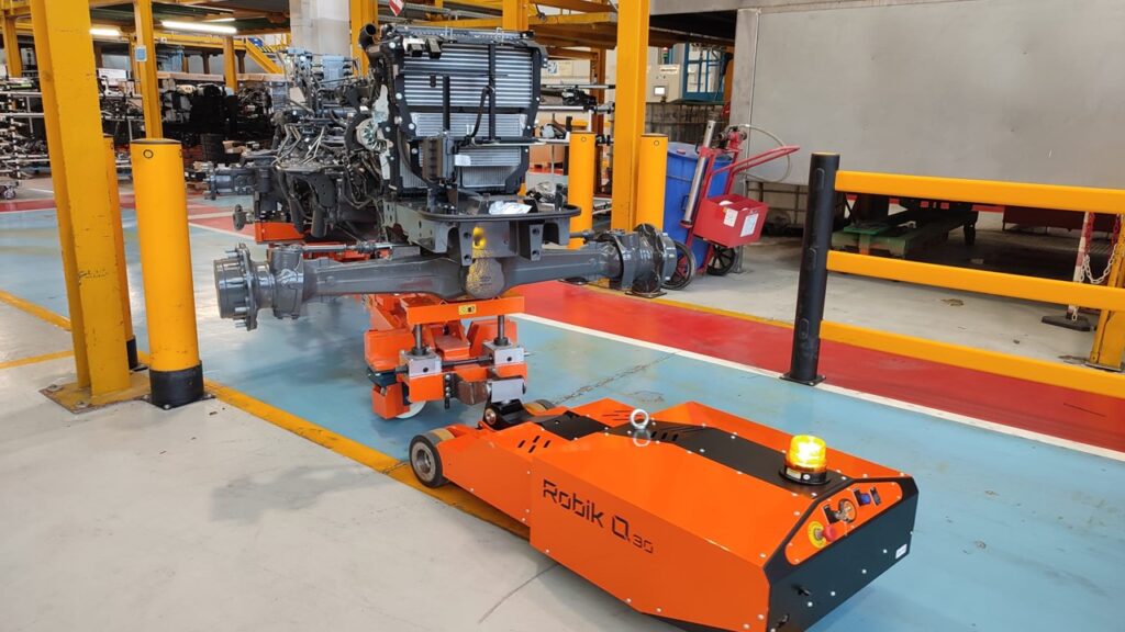 Robik Q ELECTRIC TUG is handling earth moving machine