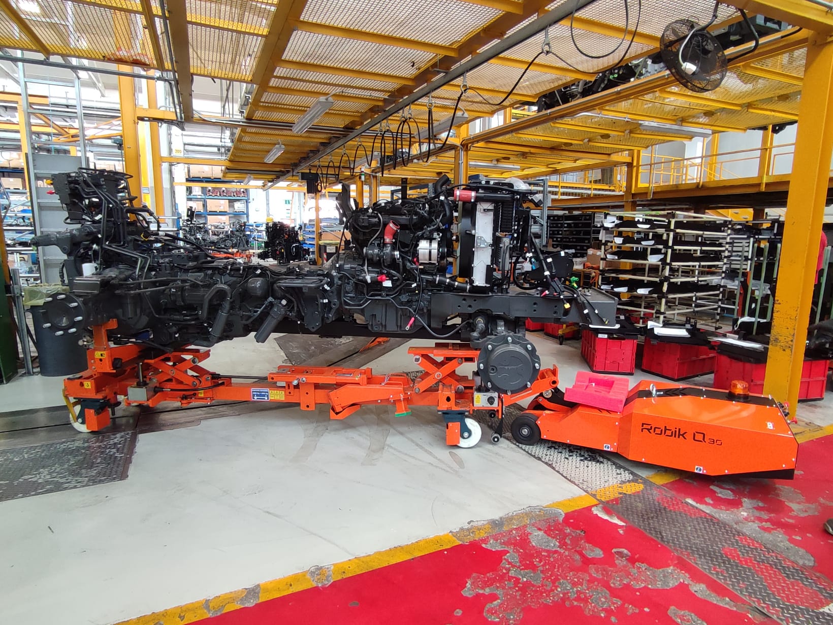 EARTH MOVING MACHINE SECTOR Robik Q30 handles component in production area